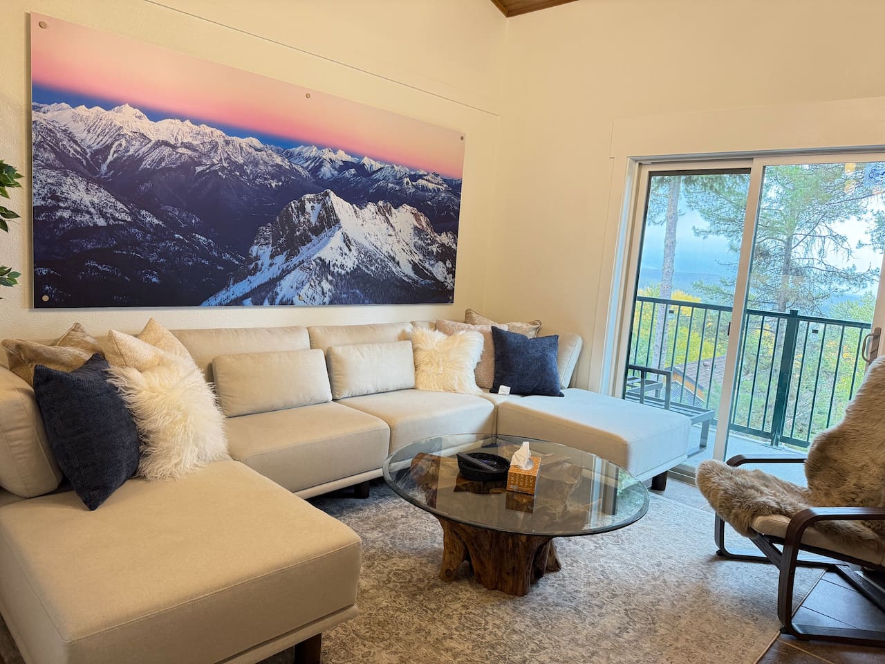 Rocky Mountain Views: Relax on the comfortable sofa and enjoy panoramic Rocky Mountain views through the large patio doors that lead directly to the balcony.