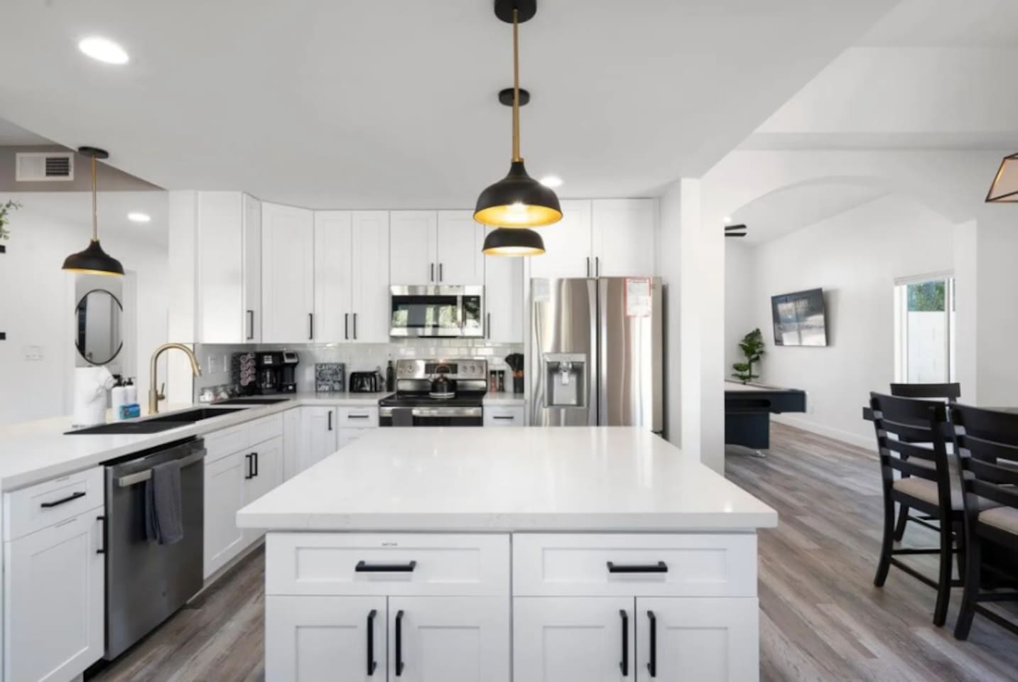 Chef's kitchen with stainless steel appliances, large island, and open floor plan perfect for cooking and entertaining.
