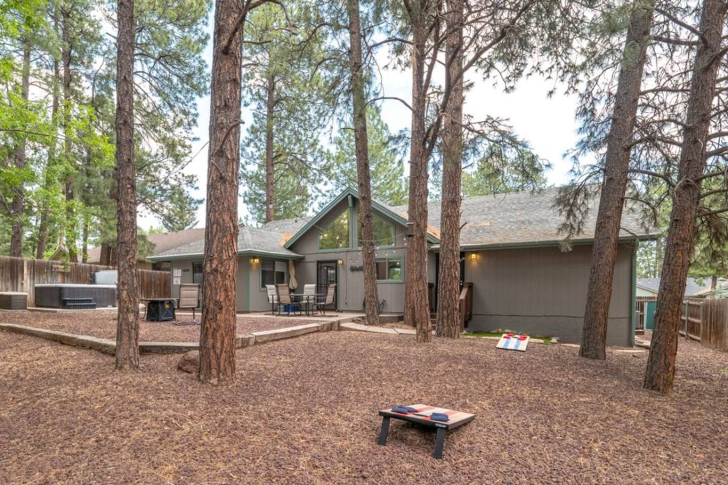 Outdoor space with pine trees, seating, and a peaceful setup for evenings outside.