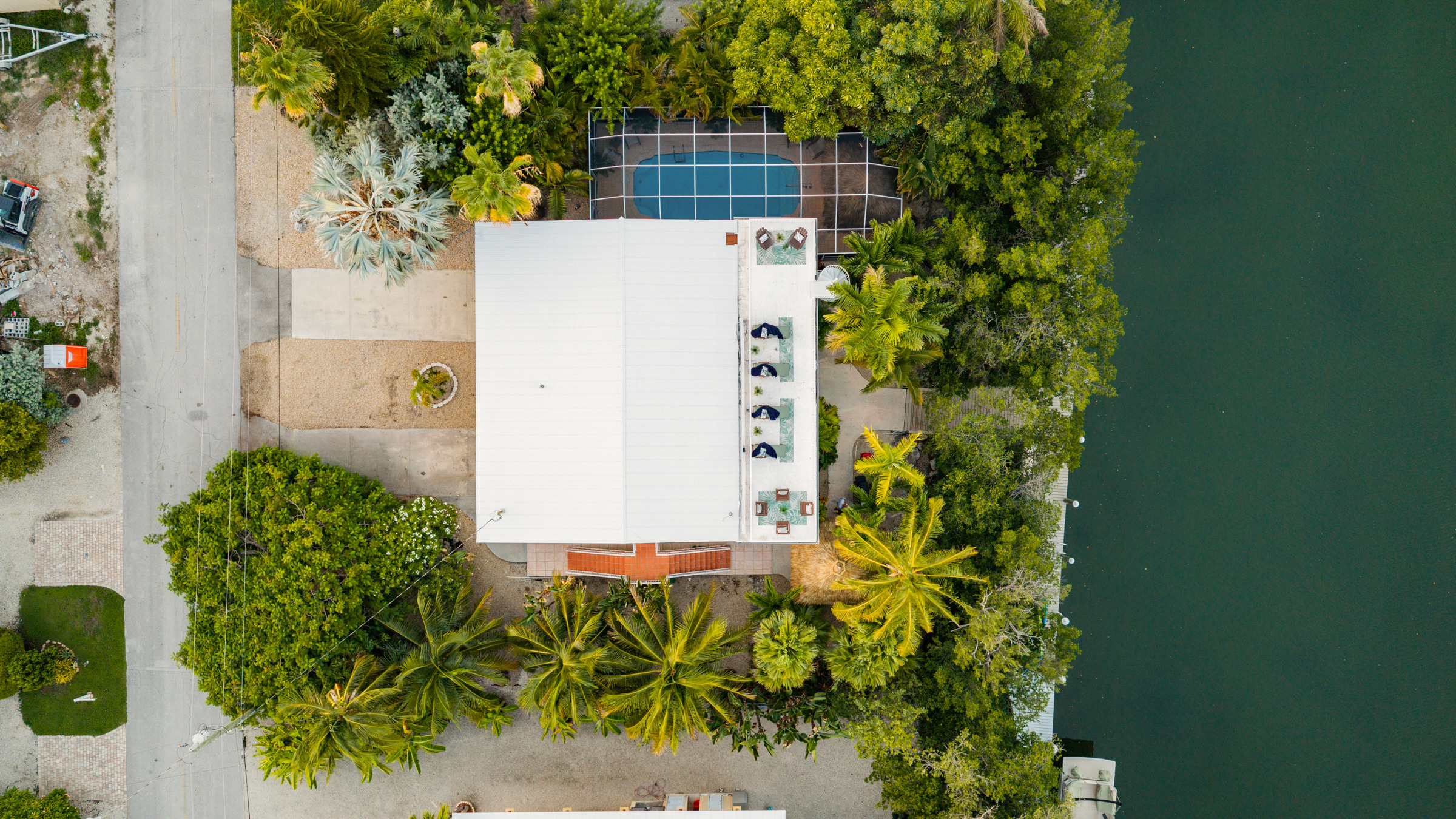 Tons of parking in the front for all your vehicles and boat trailers, two tiki huts, a large pool, and 100 ft of dockage.