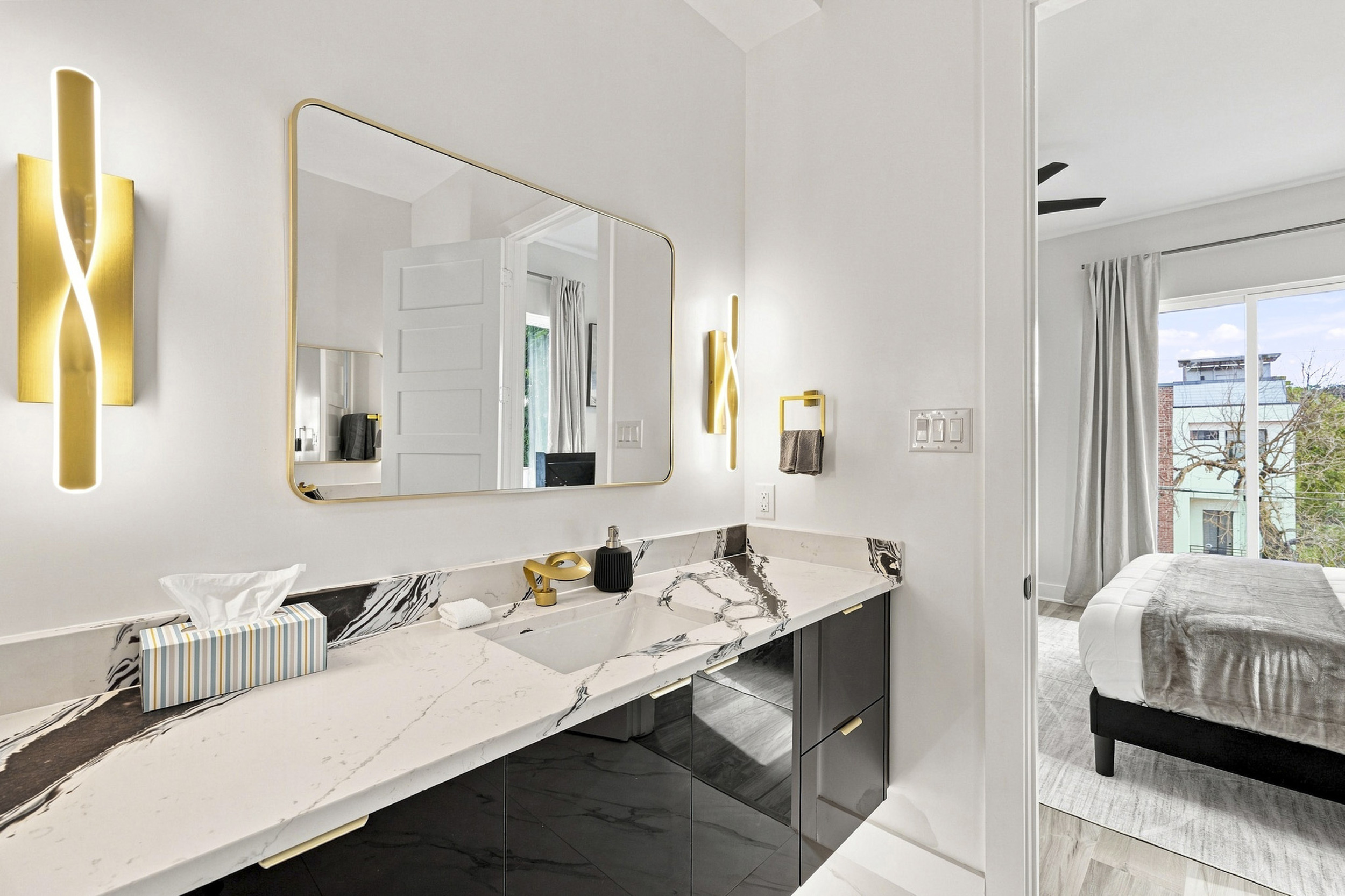 Elegant marble countertops and chic lighting create a luxurious escape!