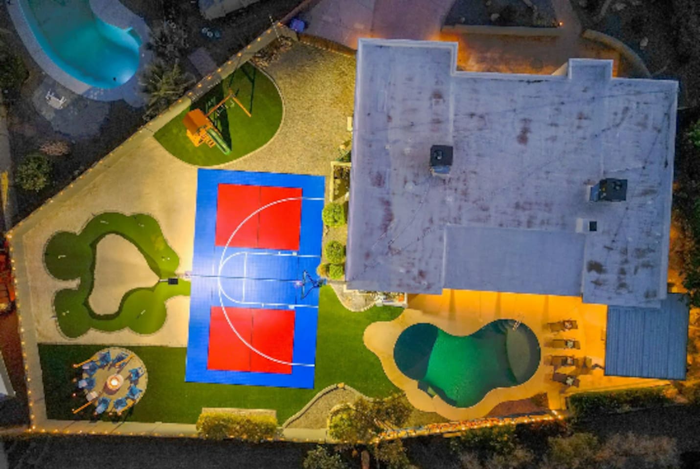 Every amenity laid out at once: pool, court, putting green, playground — a full day of options without leaving the yard.