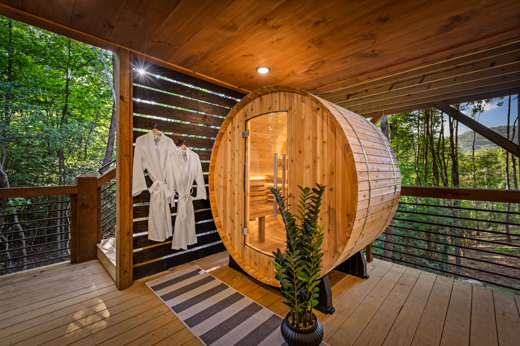 Barrell sauna with rocks and water bucket and ladle