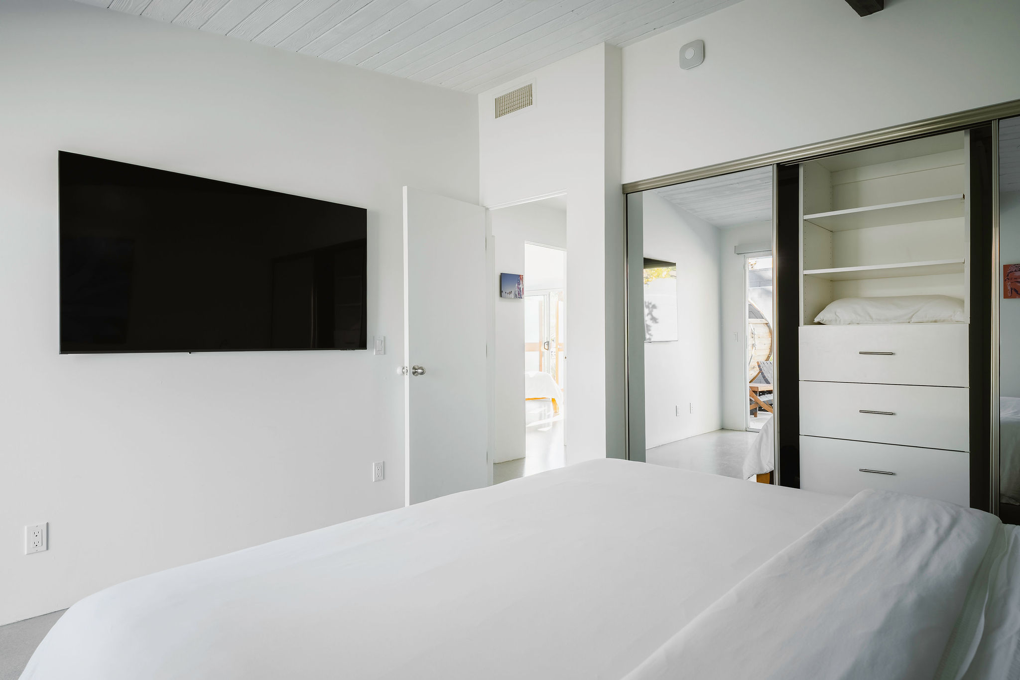 Middle bedroom with SMART TV and access to small patio 