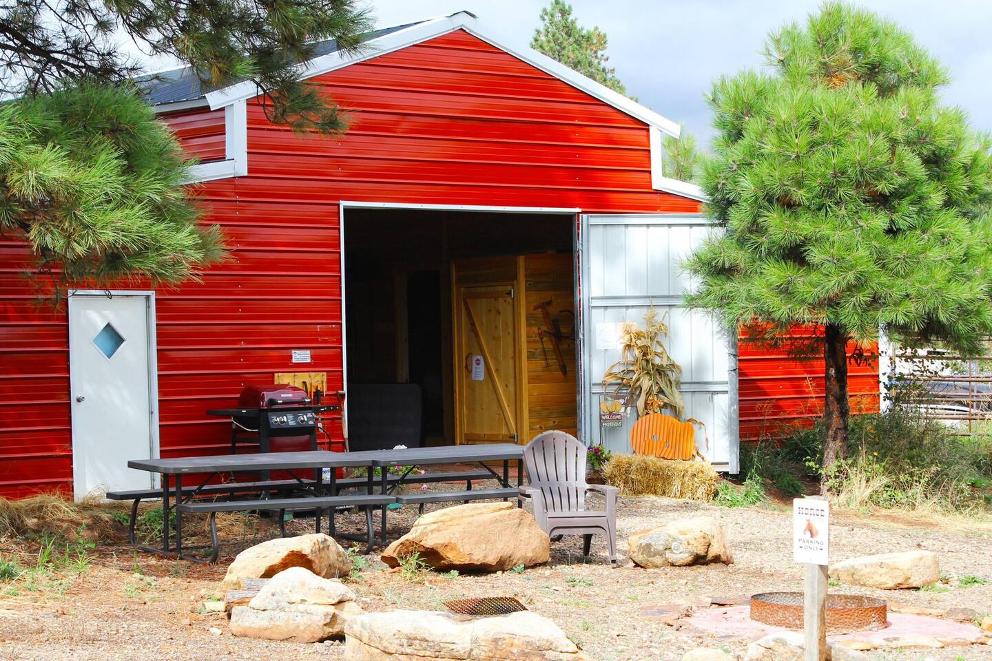 The Horse Barn includes 3 cabin suites (Bed and Bath), Kitchen, 1 Common Bathroom, and a large gathering area.