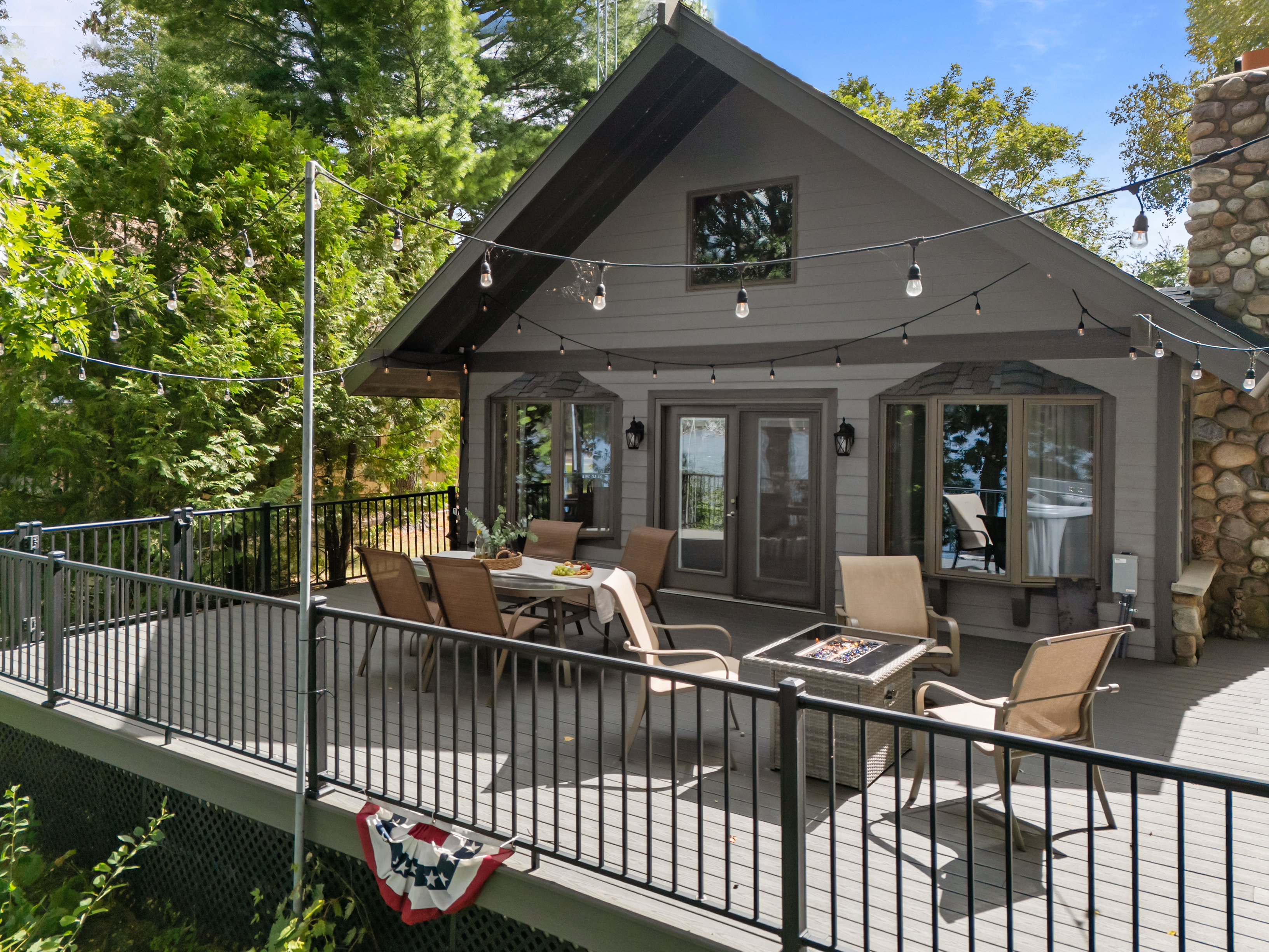 Patio doors from the living room open right onto the deck, blending indoor comfort with outdoor lake views.
