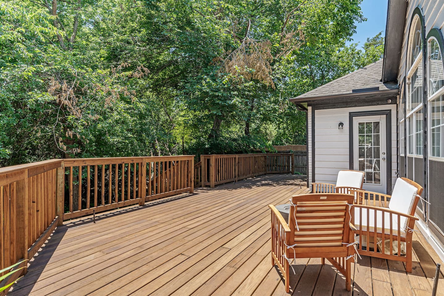Spacious deck area with nature views ideal for outdoor relaxation and sipping coffee or wine. 