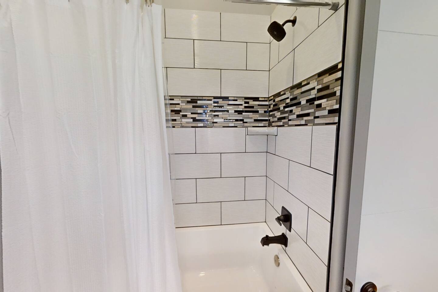 We included an extra tall shower head in the hallway restroom so you won’t have to worry about ducking to take a shower!  The tub is an extra deep soaker tub, so if hot baths are your thing we have you covered!!