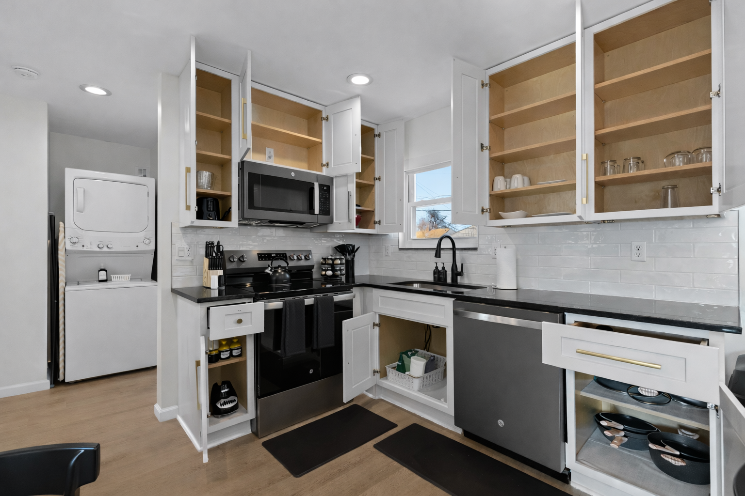 Fully stocked kitchen with ample cabinet storage, modern appliances, and everything you need for easy cooking, dining, and extended stays.