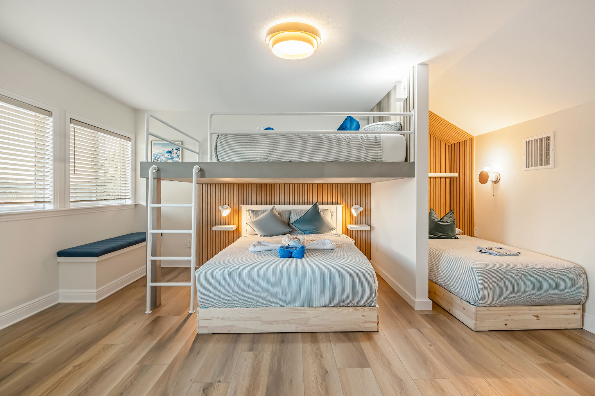 Bright family bunk room with queen bed and additional sleeping space for kids or friends.