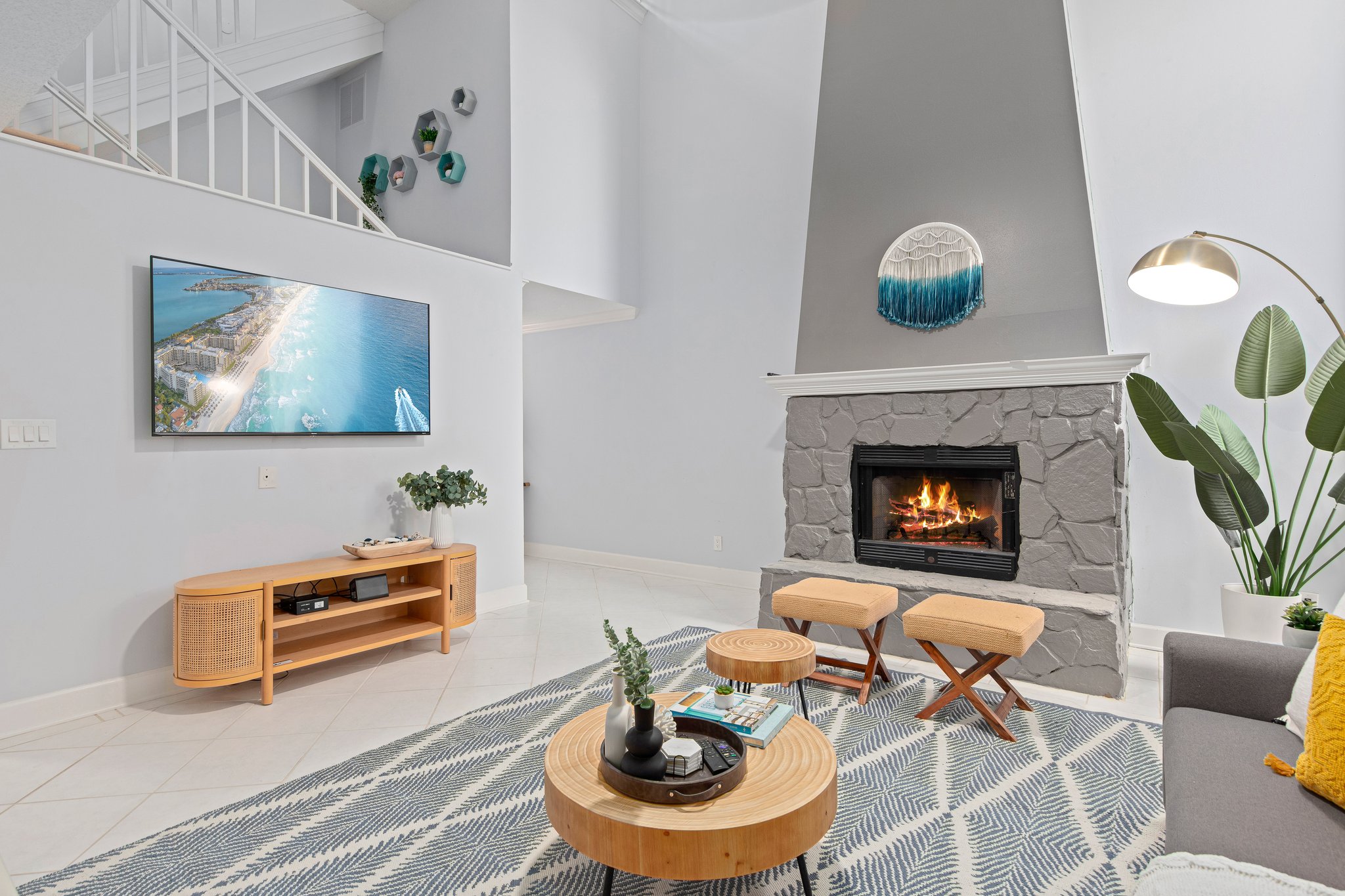 Grand living room sporting a 65" Roku TV. There's plenty of seating for the whole family to gather around and watch a movie together