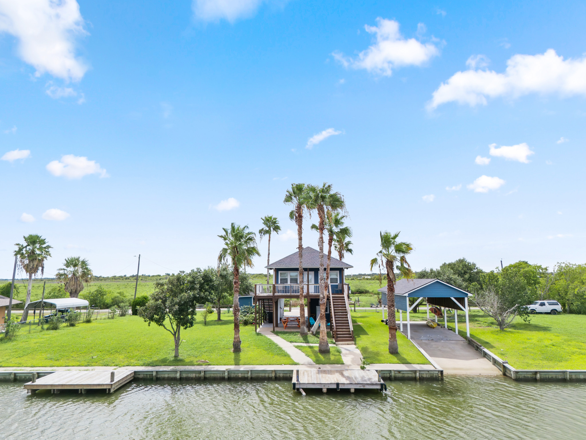 Backyard view of home and boat ramp