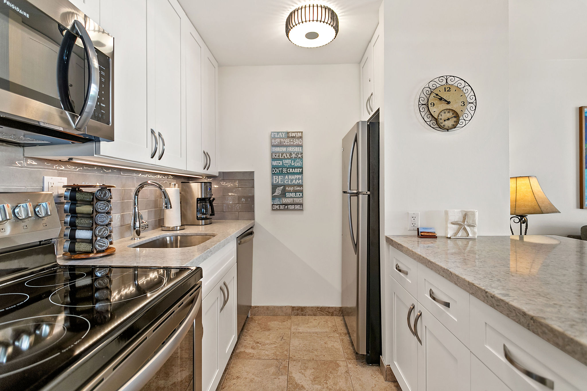 Modern kitchen with stainless steel appliances, Vitamix and spices