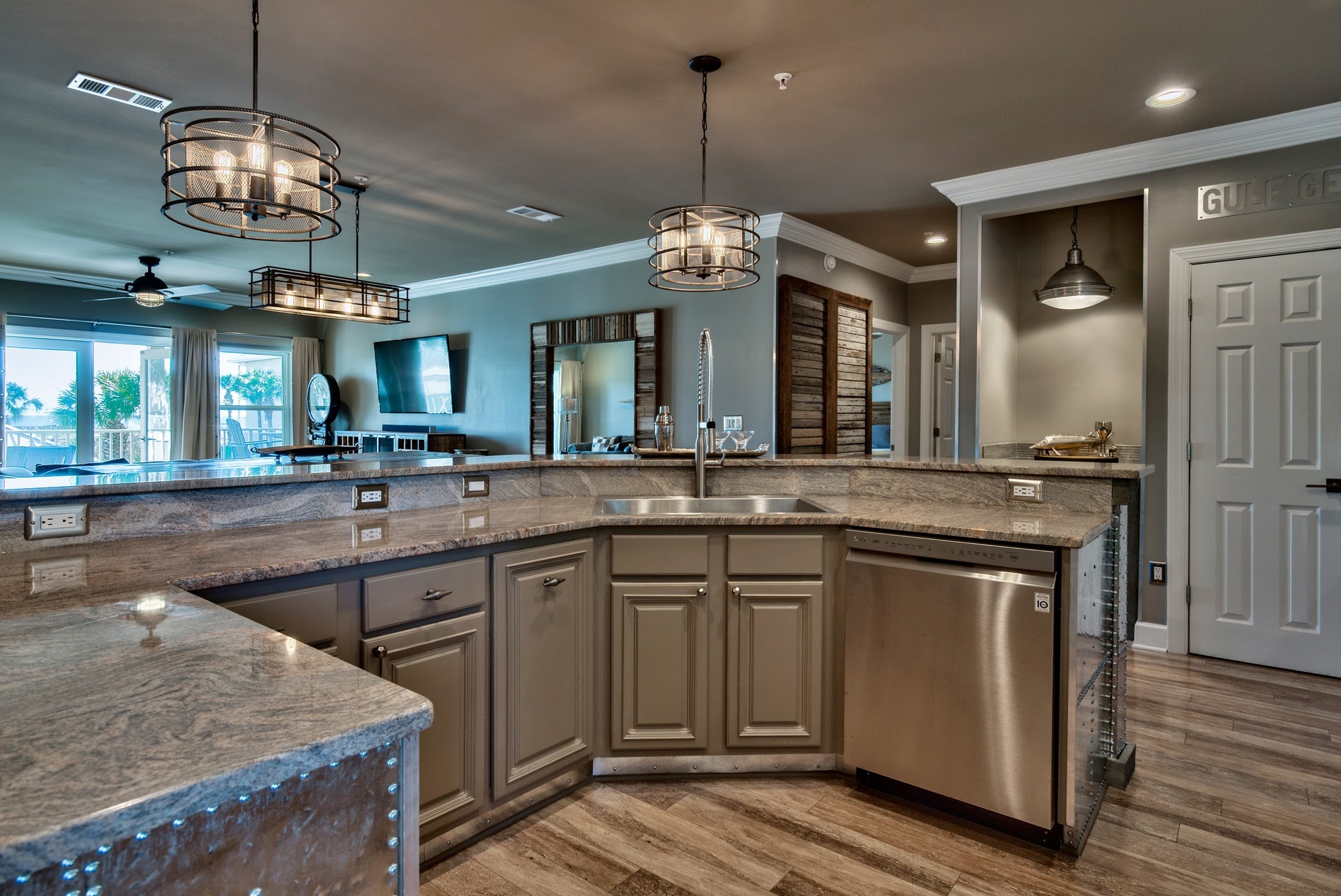 Kitchen with NOLA faucet, zero radius sink and stainless appliances.