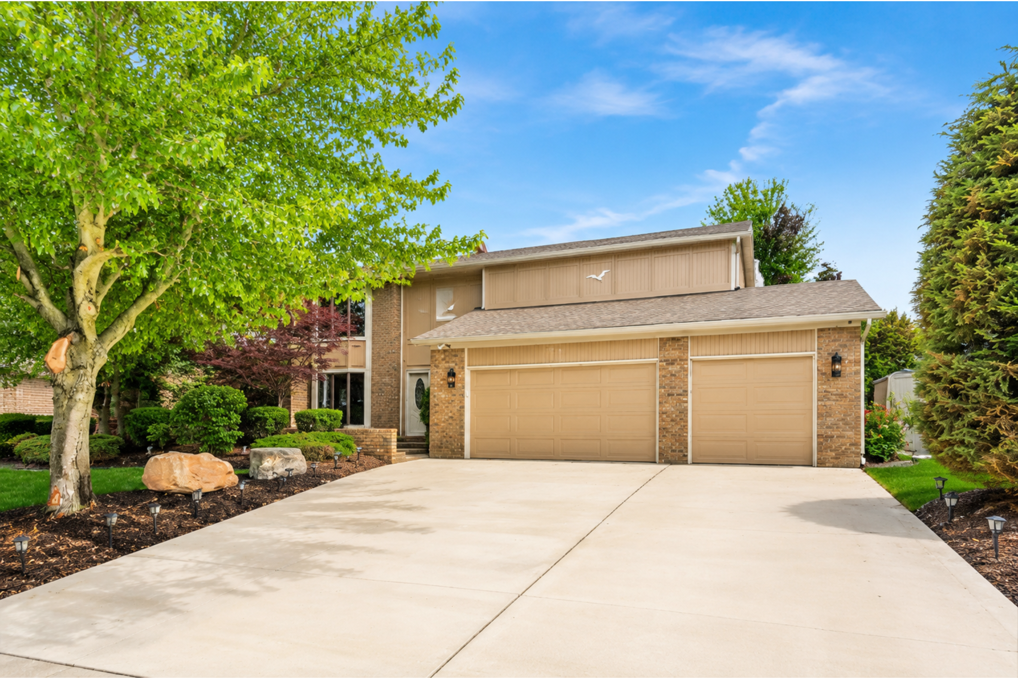 Clean, spacious home with a wide driveway and attached garage. Quiet suburban setting with well-maintained exterior ideal for comfortable, easy living and convenient parking.