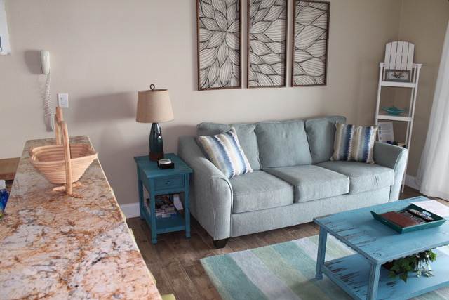 Living area with comfortable couch and queen sofa.