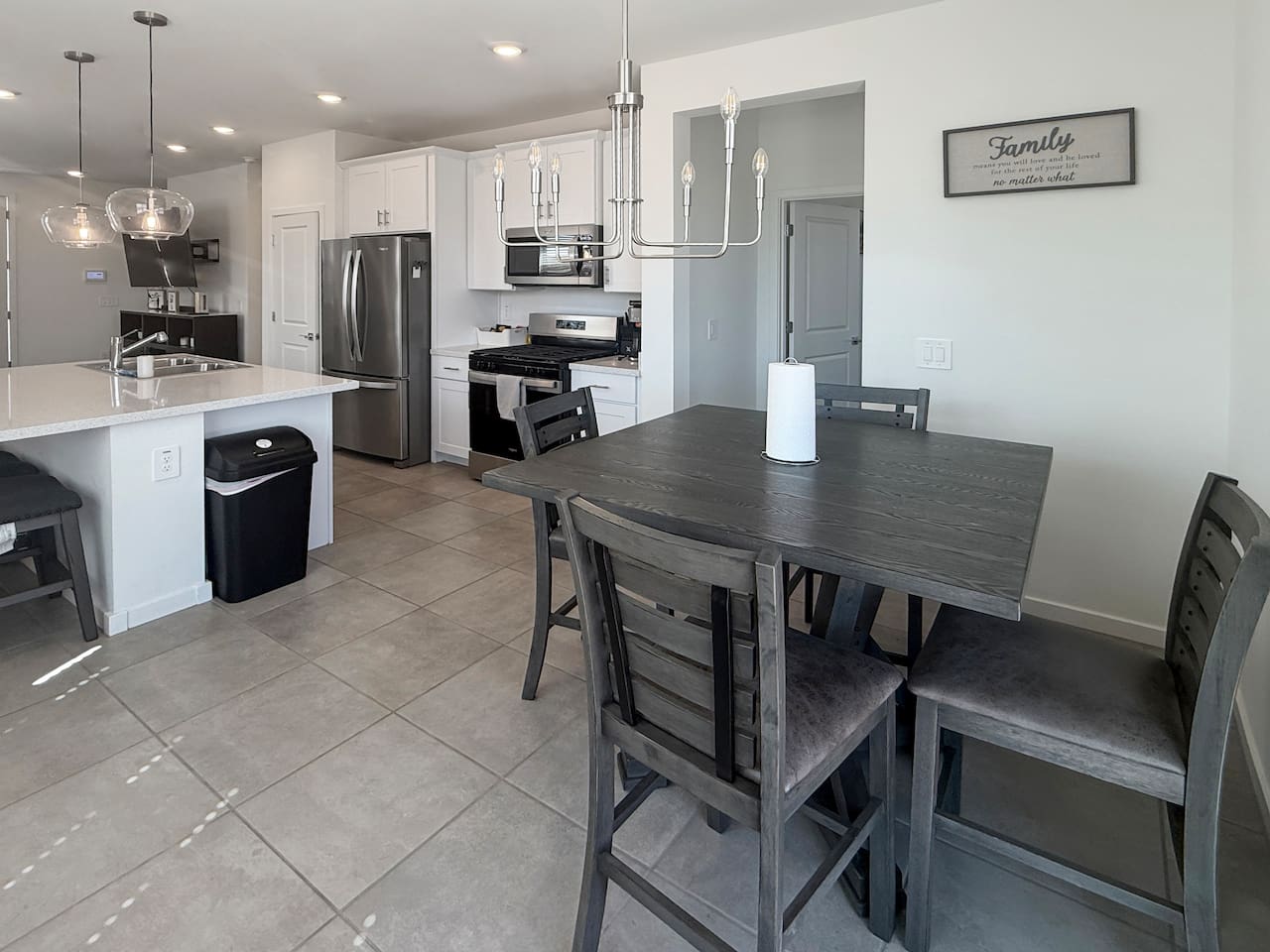 Dining table beside kitchen with four chairs