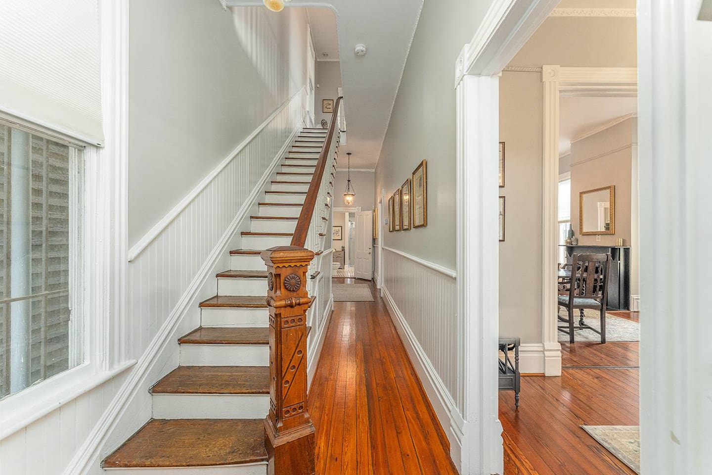 Enter in through the two grand wooden double doors and you'll feel as though you've traveled back 100 years. Heart of pine floors throughout with soaring ceilings and high quality furnishings/appliances - you'll immediately feel at home! 