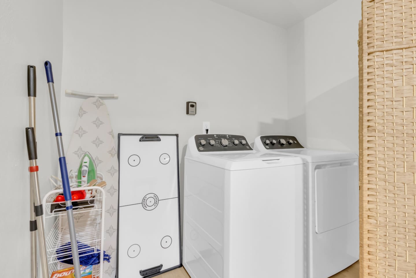 Convenient washing machine and dryer in-unit, plus cleaning products, iron and board, portable air hockey table and extra cleaning supplies—ideal for long-term stays.