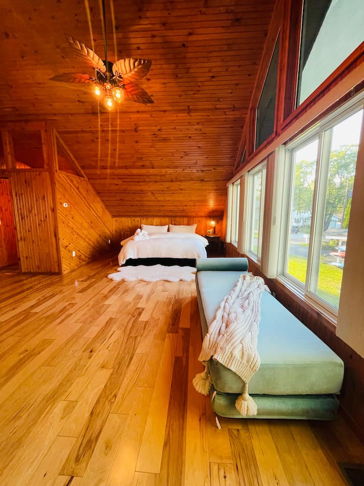 Spacious bedroom with wood interior and peaceful cabin atmosphere.
