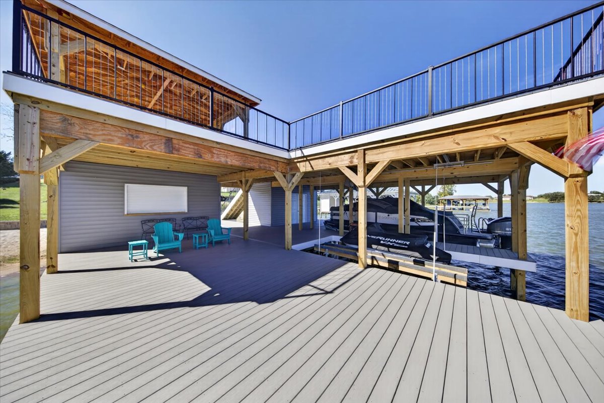 Spacious covered lower level with  seating and room to enjoy the waterfront.
