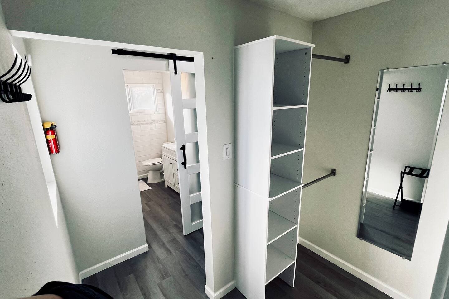 Full walk-in closet, through barn door, into the Master Bathroom.