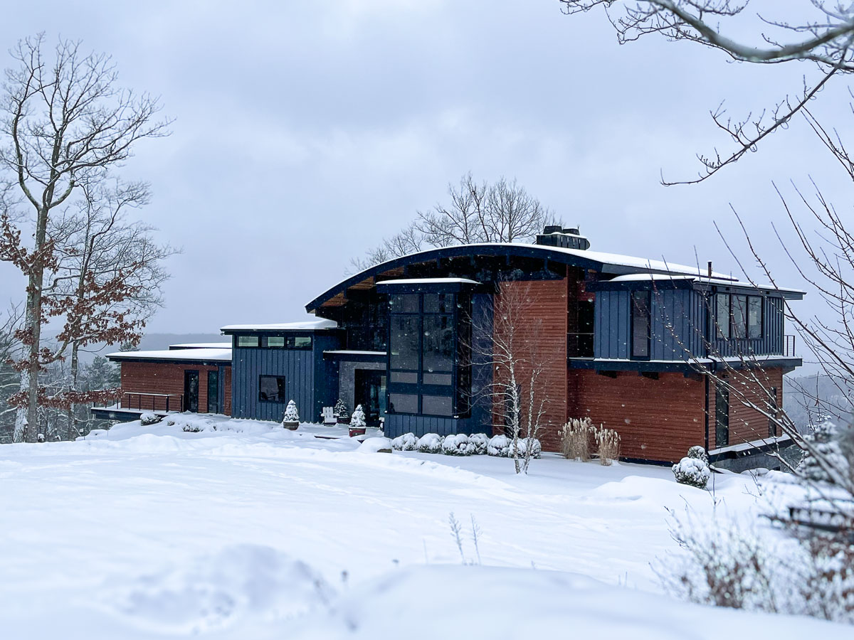 Winter exterior of Sunset Falls Estate &mdash; snow on the modern mountain home, Berkshires