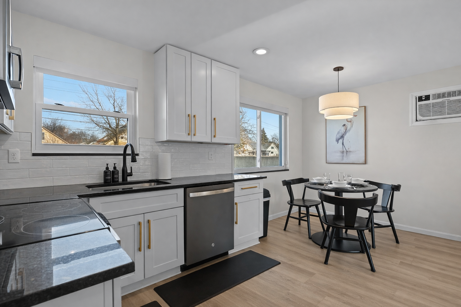 Bright kitchen and dining space with modern finishes, natural light, and seating for four—ideal for cooking, dining, and everyday comfort.