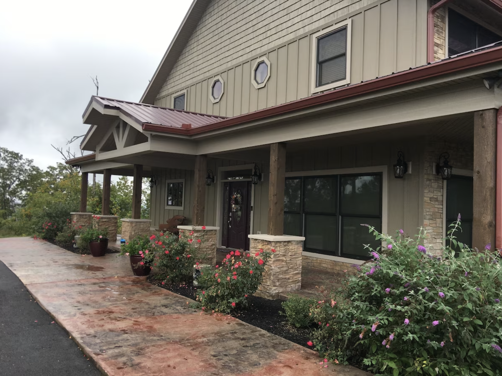 The entryway has a large driveway and welcoming landscaping to greet you.