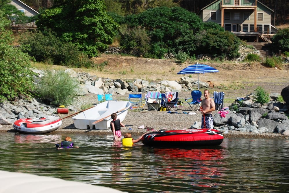 Family on the beach and dock at Palmer Lake