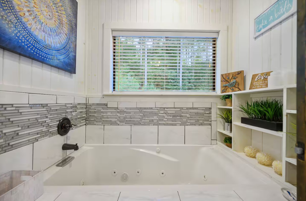 Indulge in a long soak in the jetted tub, surrounded by serene views of the woods.