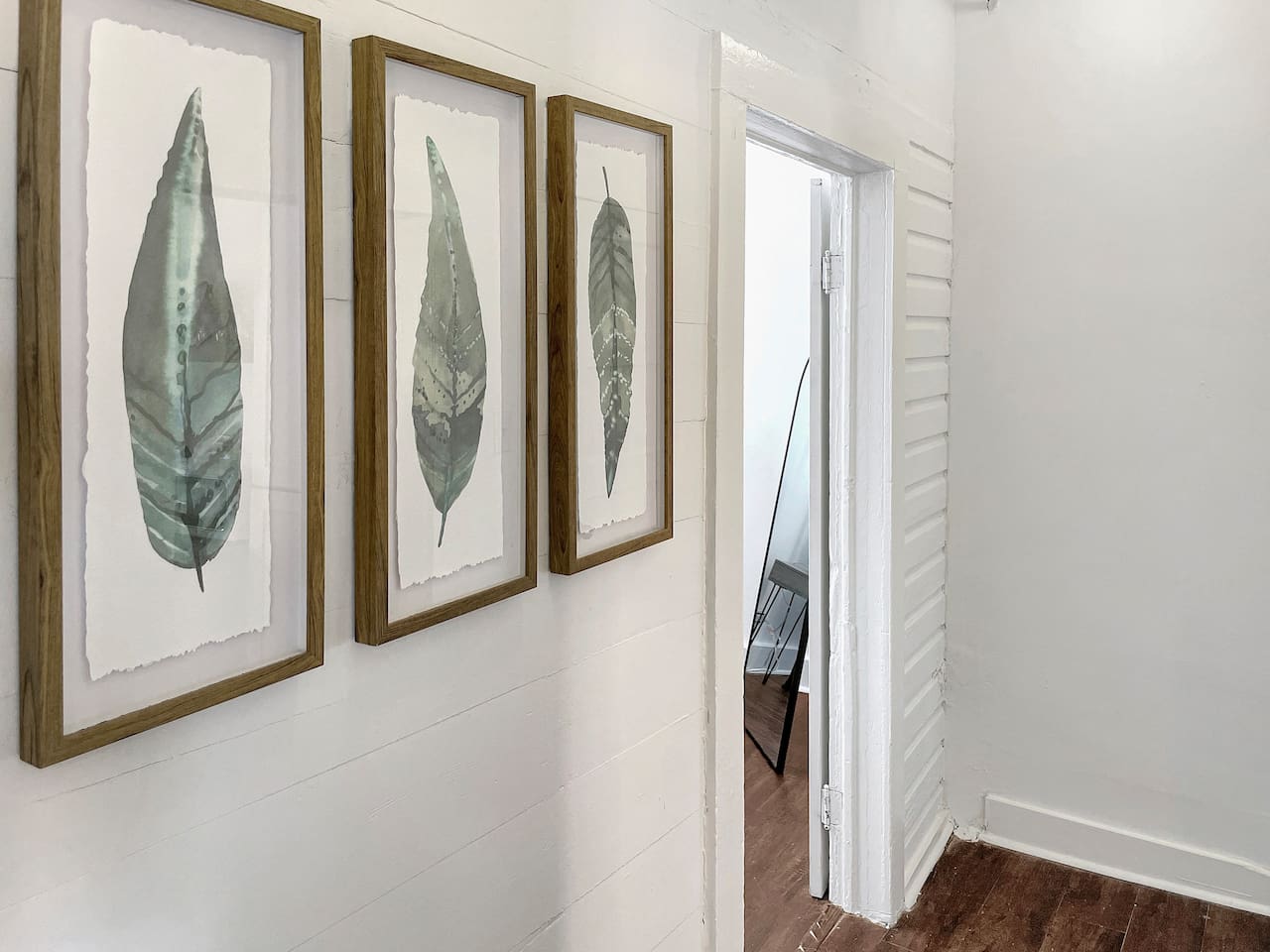 Relaxing art escorts you to the back bedroom and fully renovated shared bathroom.