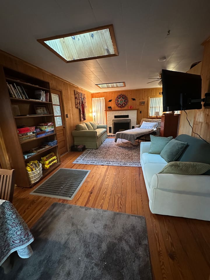 Cozy living room with two sleeper sofas — one folds into a twin bed, the other a cot-size. Perfect for extra guests! Fresh bedding is stored in the closet. Ideal for relaxing after a day exploring the orchards, trails, or lakes nearby.