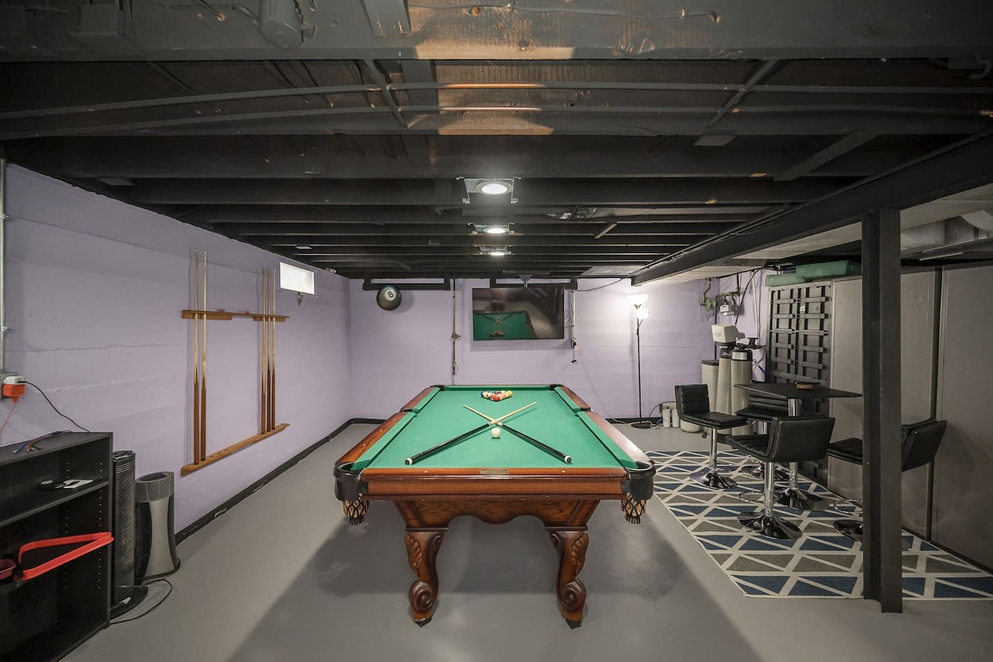 Enjoy the pool table while watching a game on the TV