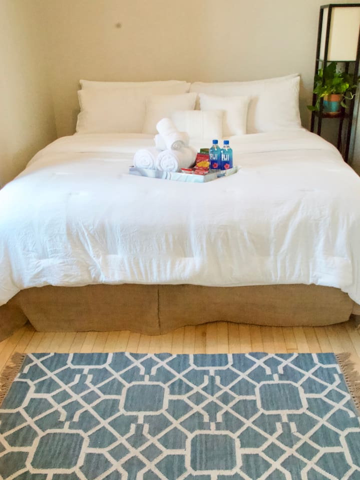 Comfortable King bedroom with plush bedding designed for a restful night's sleep.