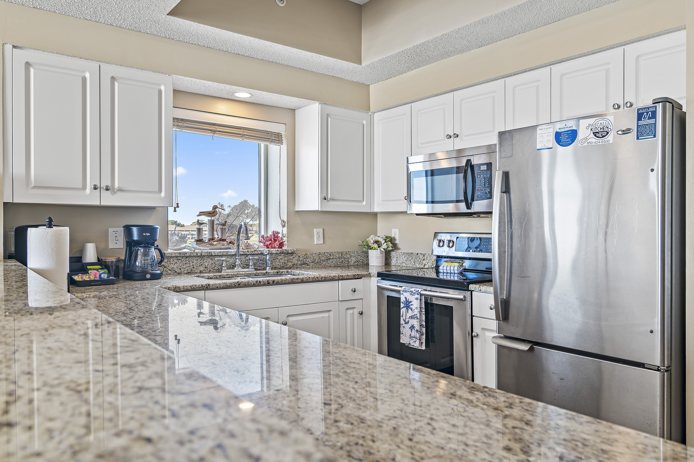 Kitchen has stainless appliances and granite countertops - fully stocked with more than the basics (coffee/tea bar, oils/spices, Tupperware, plenty of pots/pans/cookware)!