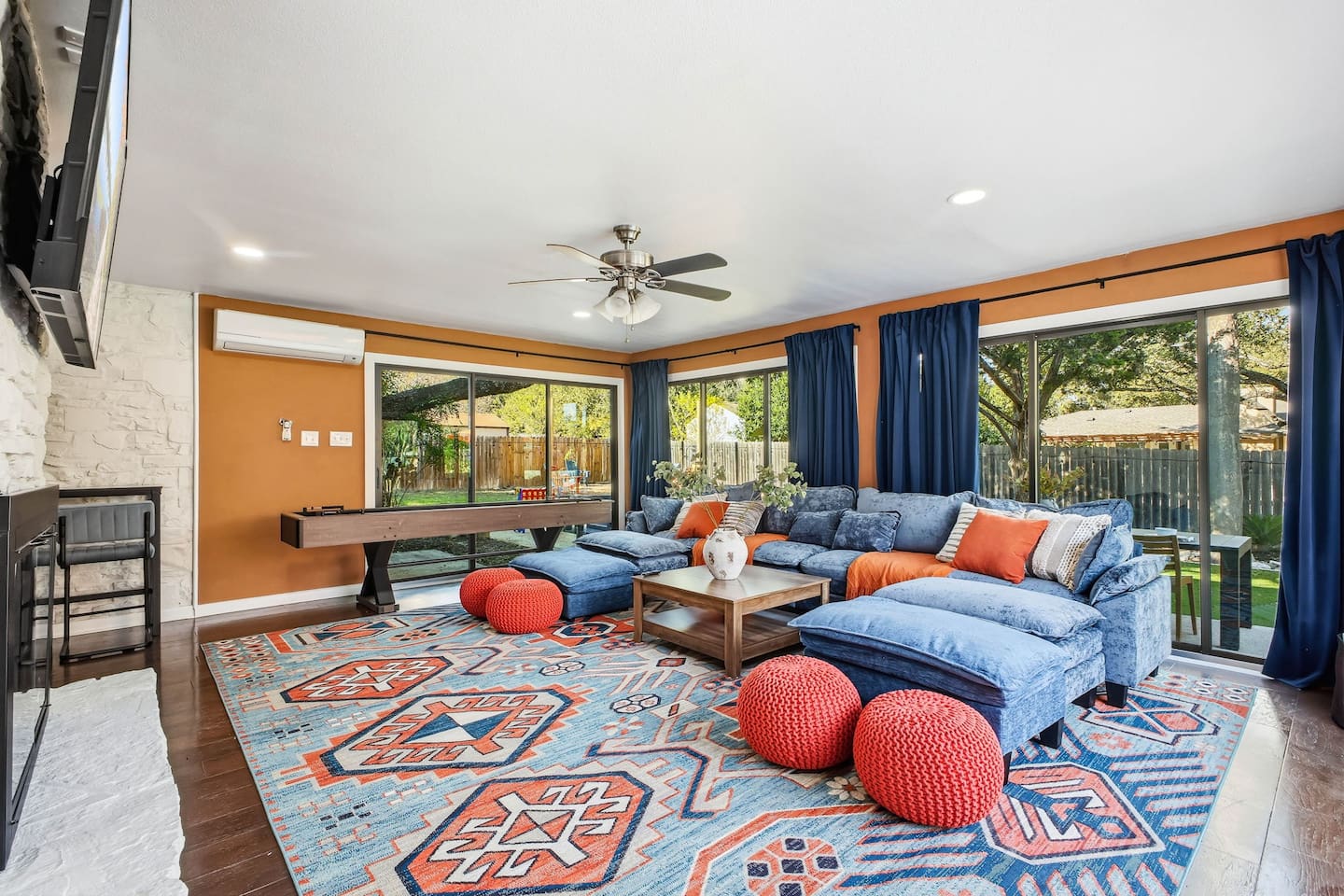 Large living room with a shuffleboard table in the background