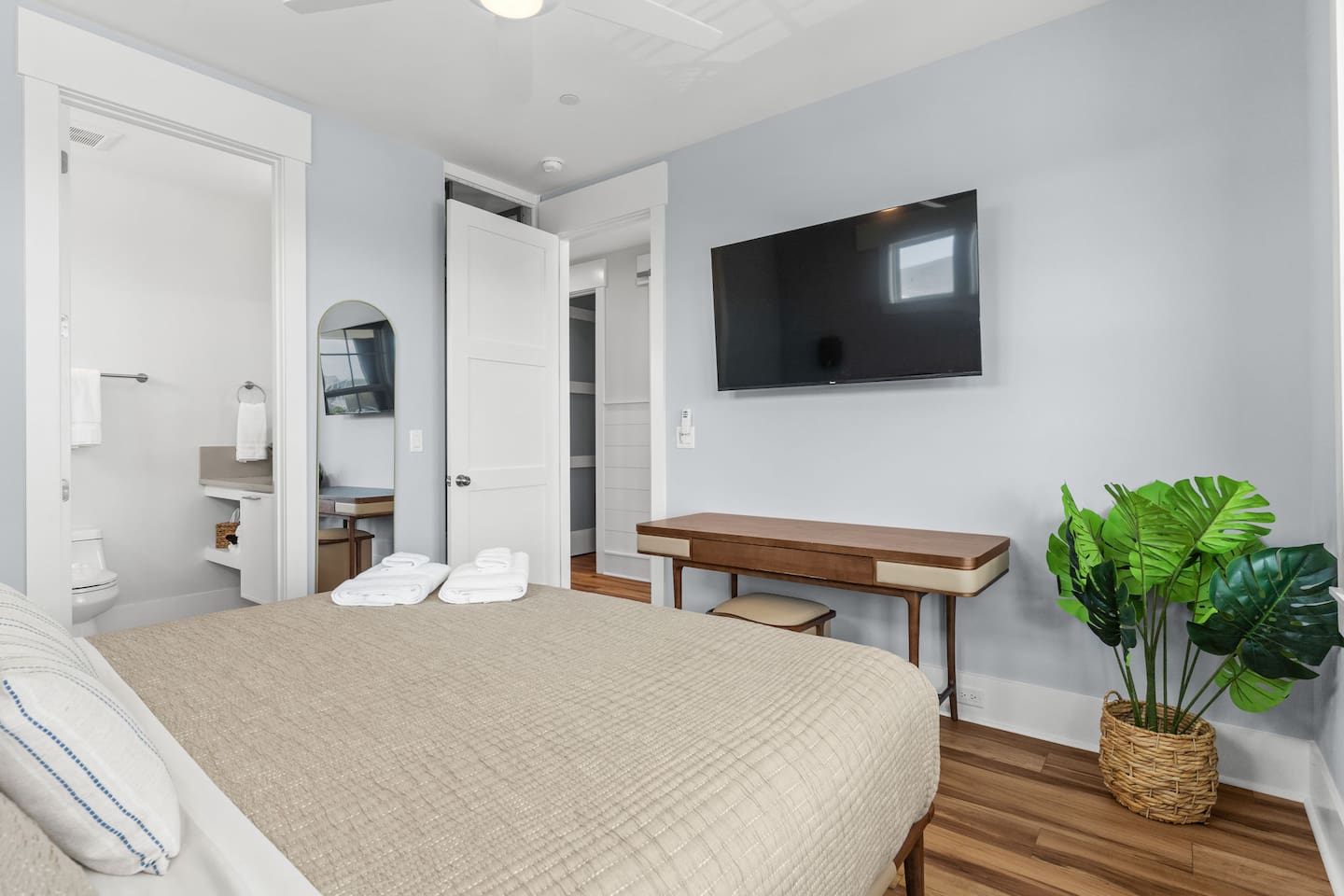 Located directly across from the game room, this room features a dedicated workspace, 55-inch smart TV, full length mirror, and wardrobe.