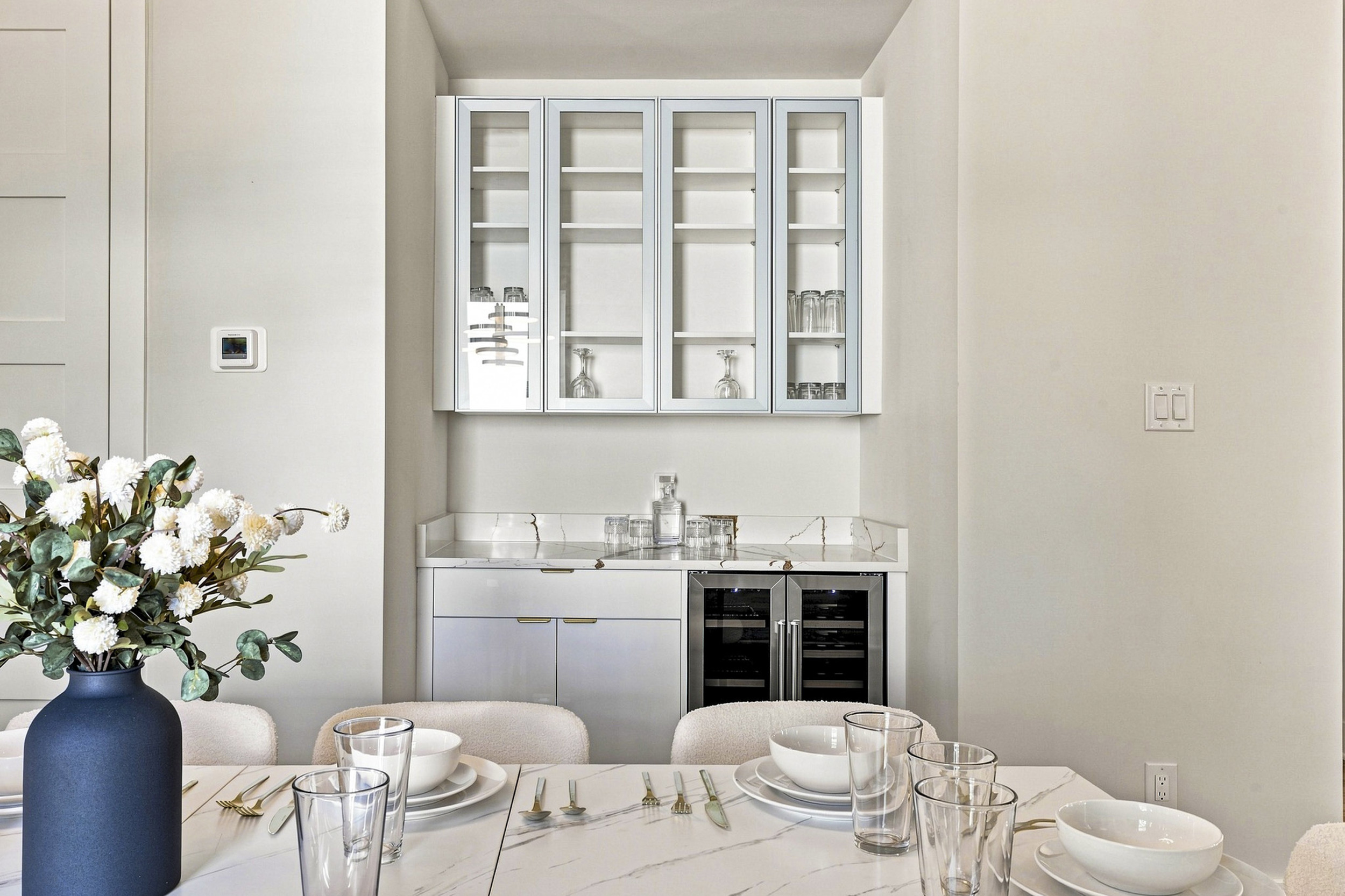 Elegant space with a chic marble table and stylish bar for delightful gatherings!