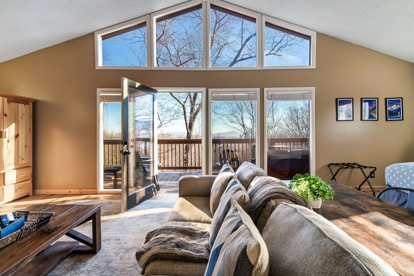 Lovely master bedroom suite with its own living area, stone fireplace, vaulted ceiling, and a  private deck with a seasonal view. Plus desk.