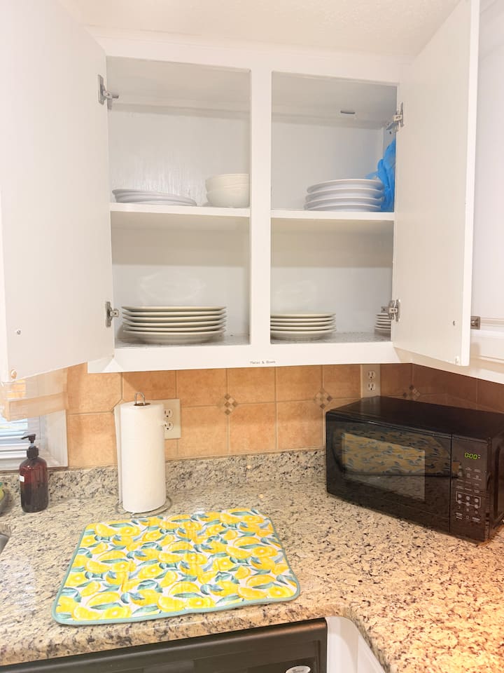 Microwave, paper towels, and generous counter space make this kitchen efficient and ready for everyday convenience. 