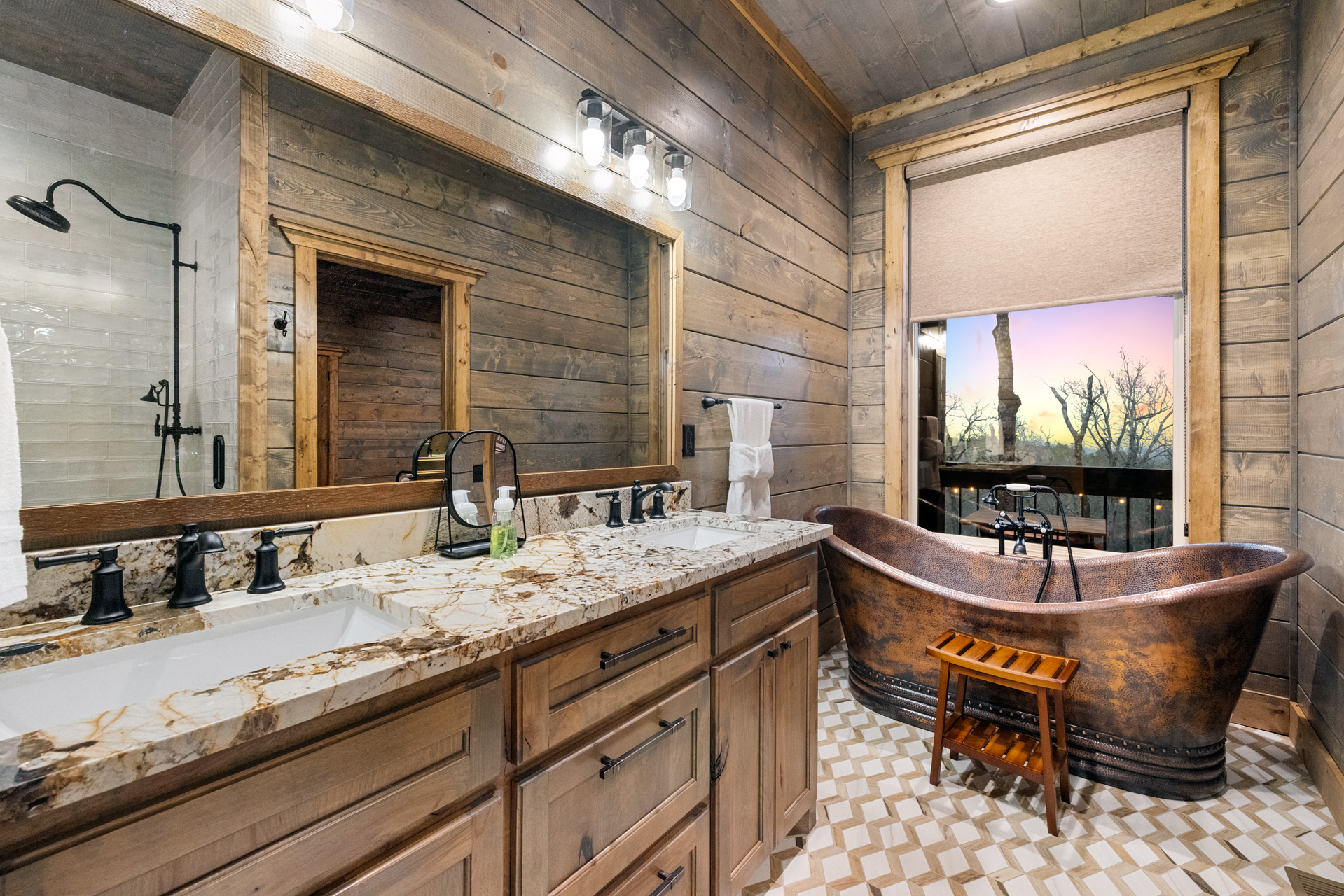 Luxury bathroom featuring a stunning copper soaking tub and elegant finishes