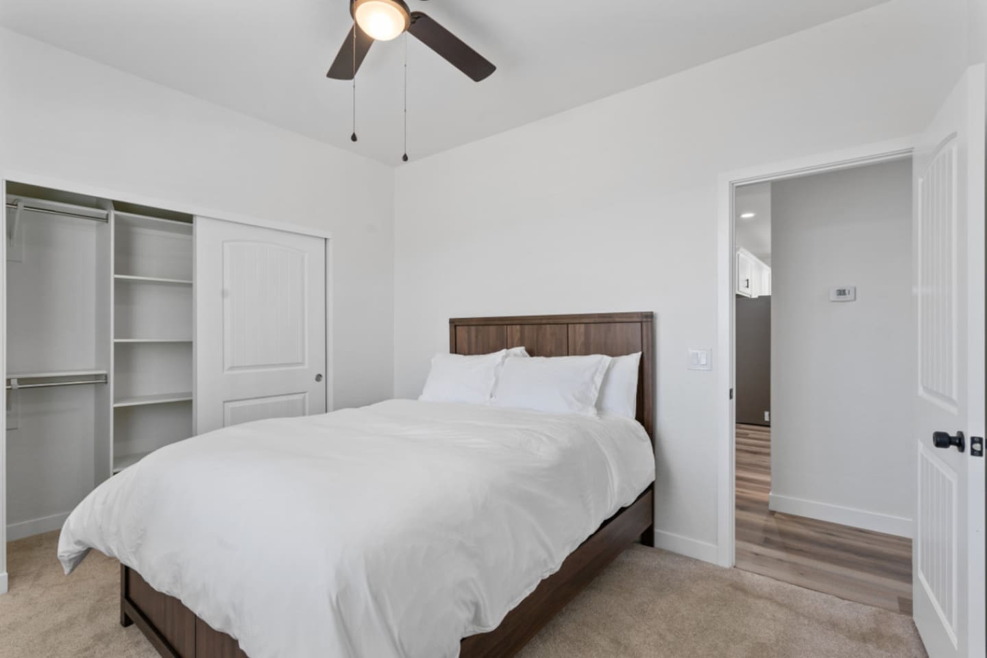 Bright guest bedroom with a comfortable bed, and spacious clothes storage 