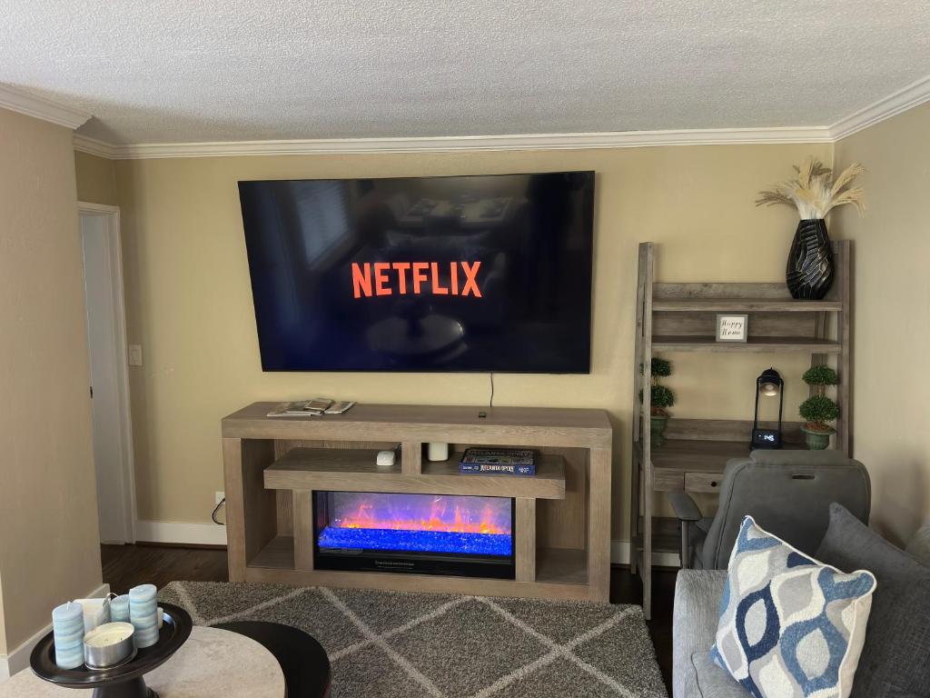 Bright living room w/ plush seating & TV, perfect for relaxing after a day out.