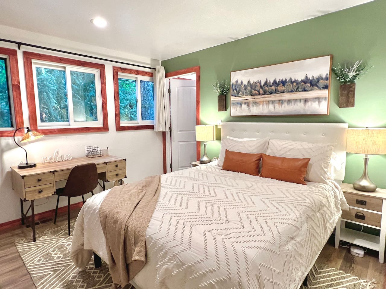 Queen bedroom with on suite bathroom, work desk, and seating area