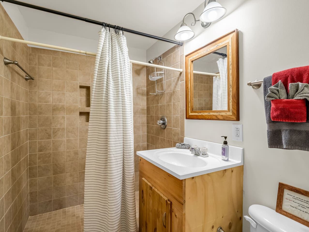 Spacious walk-in tile shower located in the basement-level bathroom, privately accessed by the basement-level bedroom