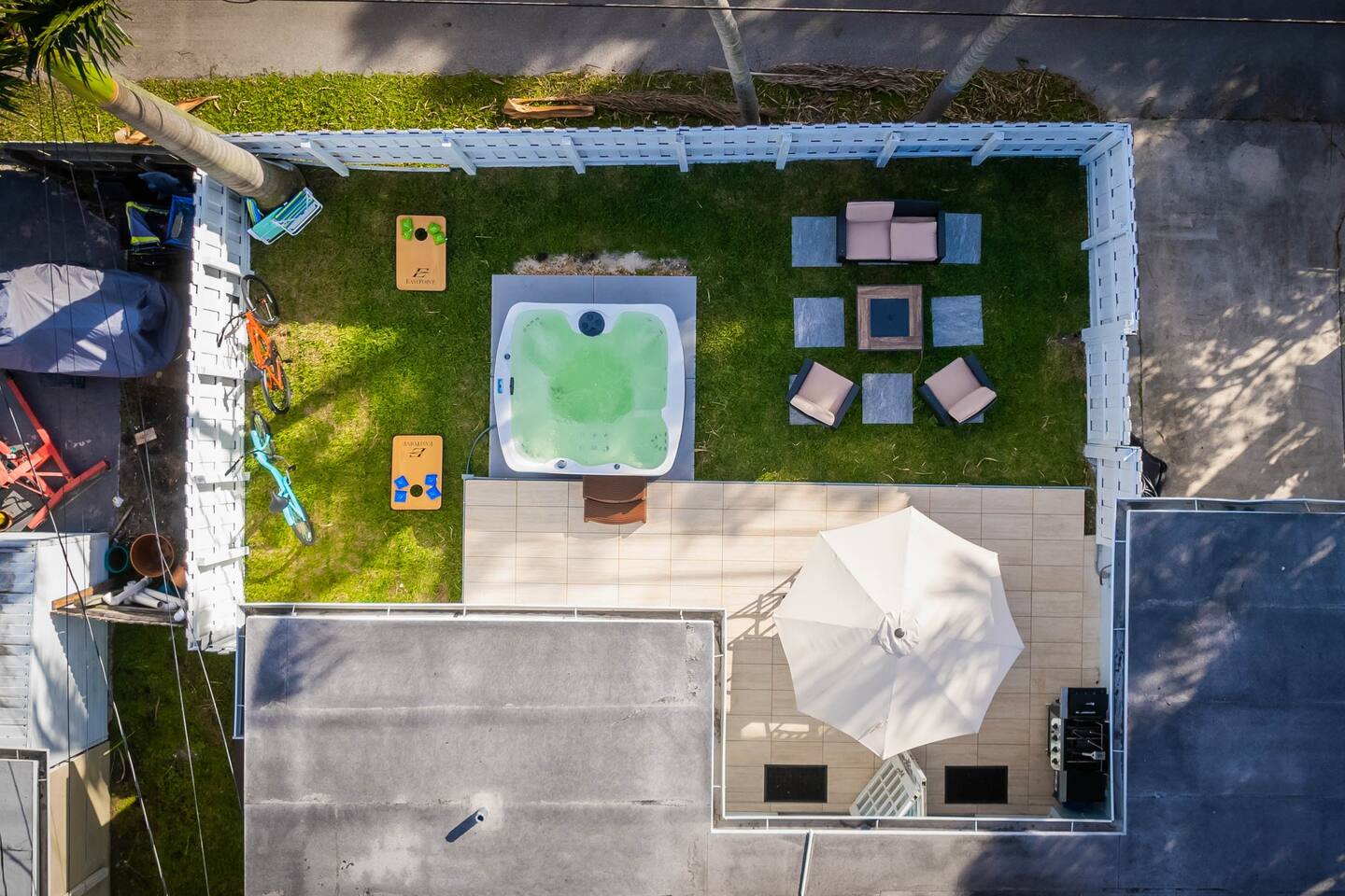 Dine/ BBQ on the patio at the 6 seater dining table and umbrella. Or relax in the new 6 seater hot tub. For those chilly nights, enjoy sitting around the gas powered fire pit lounging areas. The space lit up by remote controlled string lights.