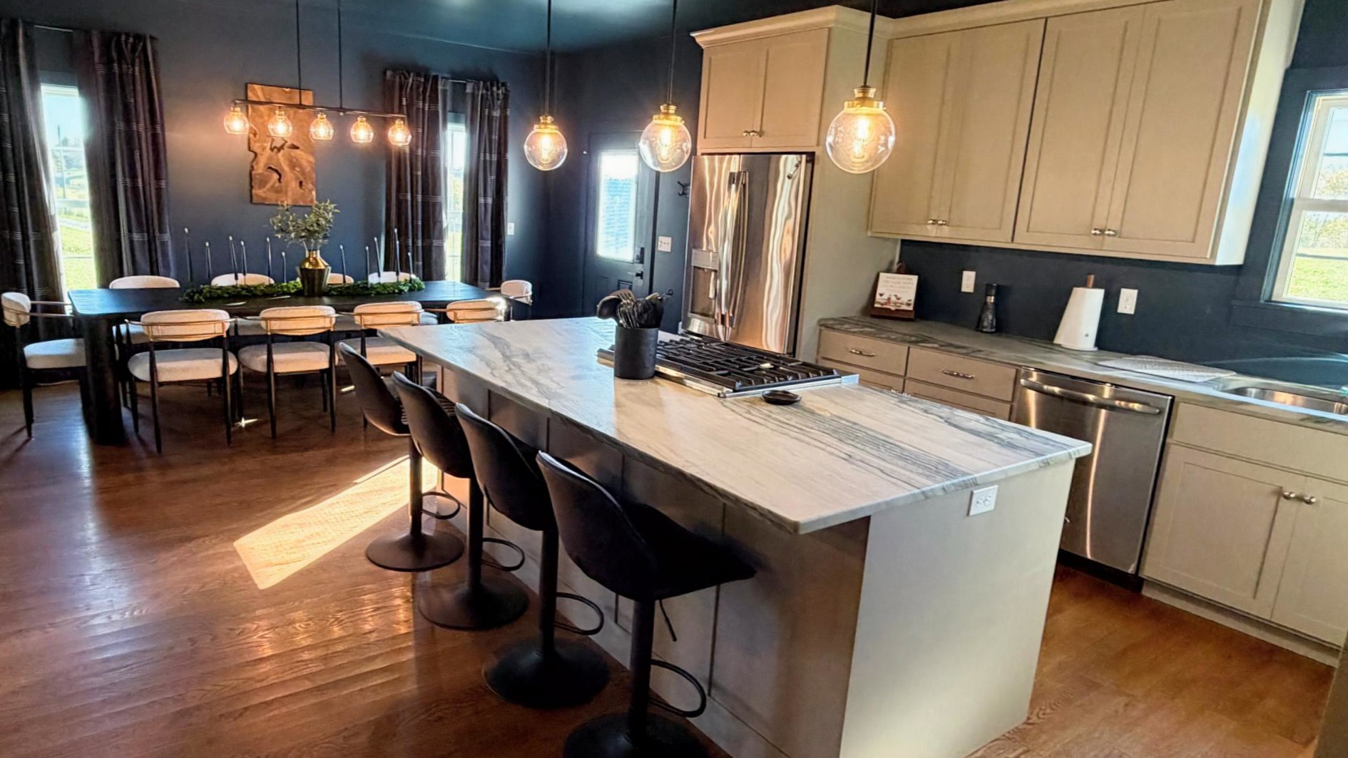 A chef-inspired kitchen designed for connection — with stone countertops, artisan lighting, and premium appliances ideal for tastings, chef dinners, and effortless entertaining.