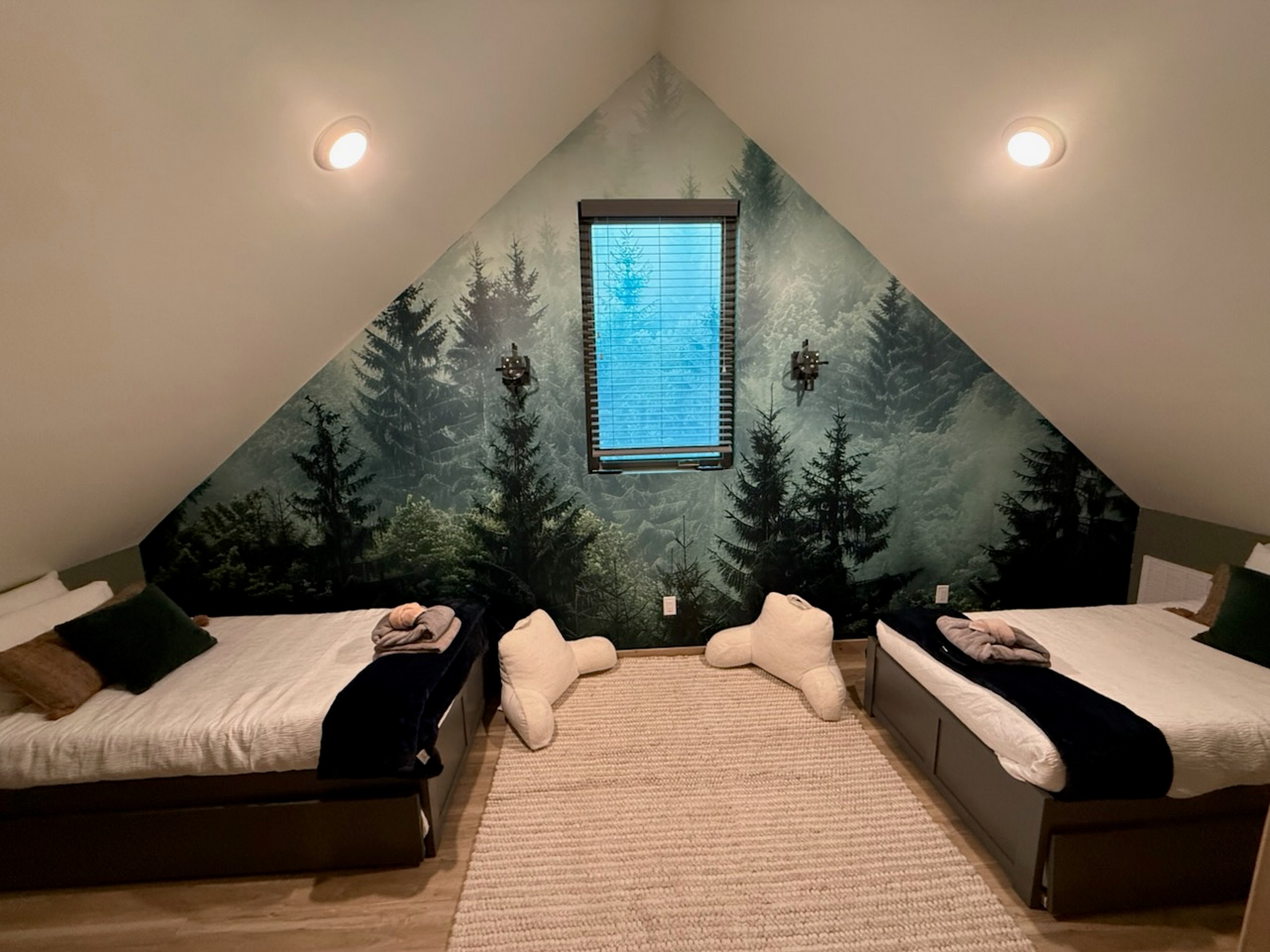 Get lost in the forest, in this cozy upstairs retreat that sleeps 4 with 2-twin trundle beds.