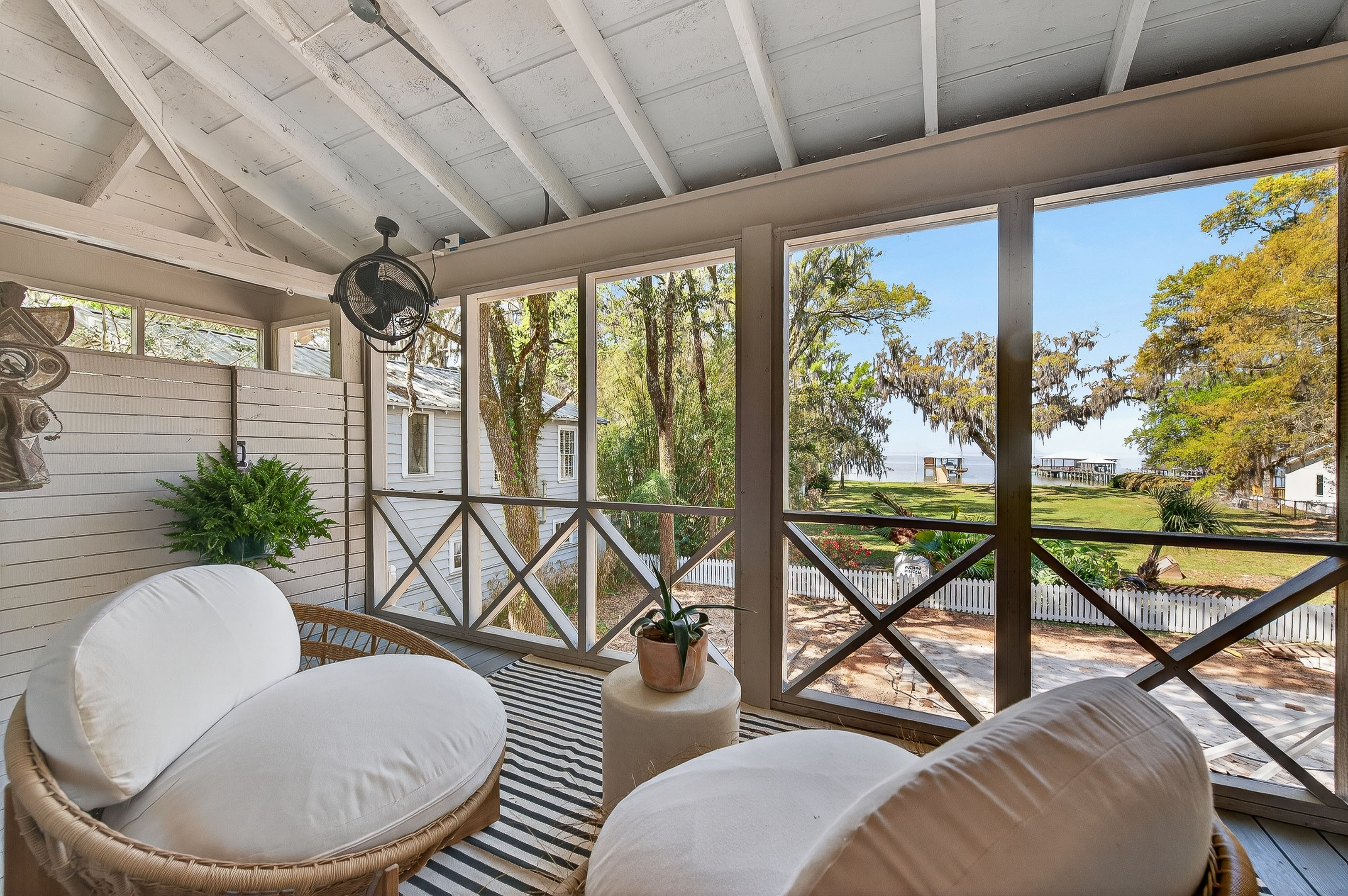 Screened porch with tranquil water views—your go-to spot for morning coffee, sunset wine, and slow coastal living 🌿